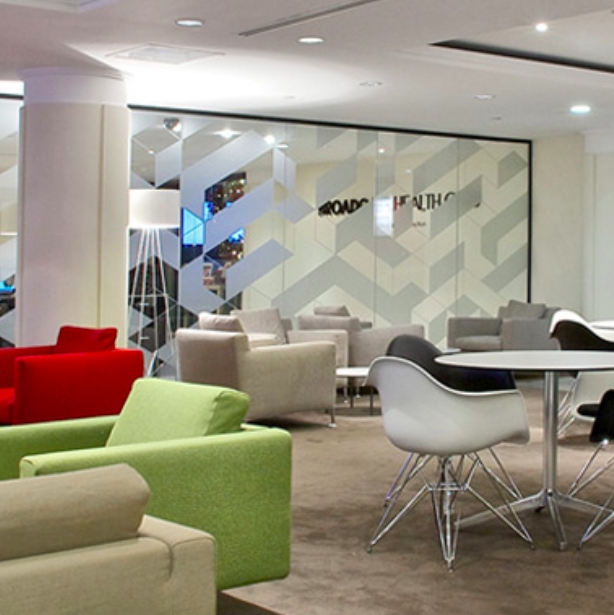 Healthcare waiting room with tempered glass walls.