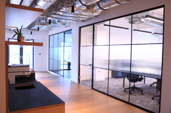Two office spaces side by side modern glass office partitions