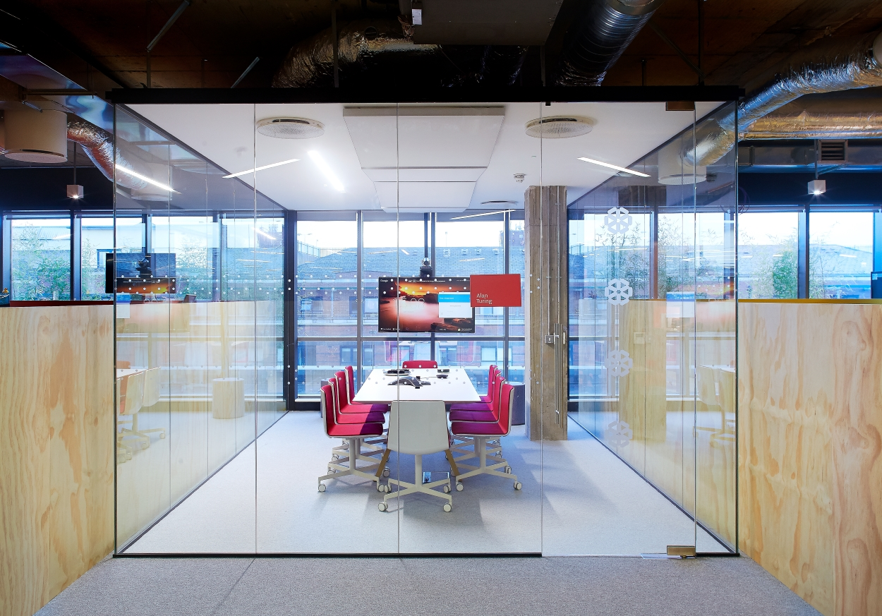 an image of a table between two large glass partition walls