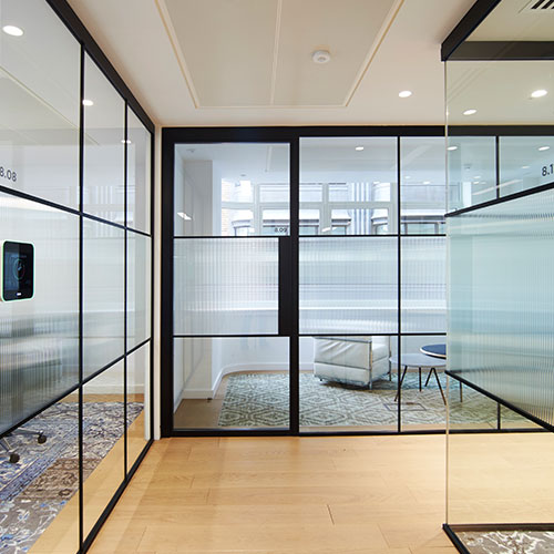 a contemporary office space with large glass doors