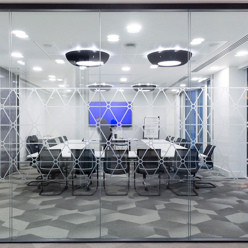 a glass wall with geometrically-designed panels