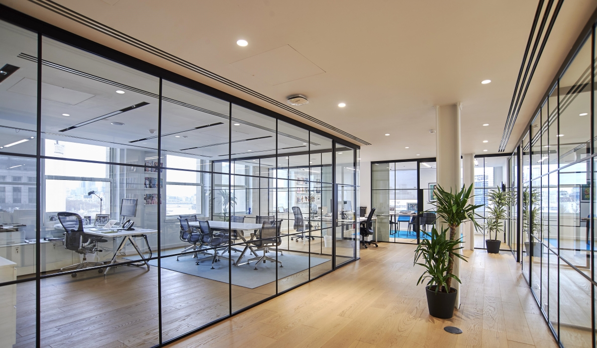 office space with multiple glass office enclosures 