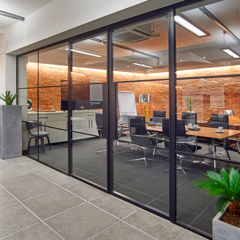 an industrial and chic conference room with large glass doors