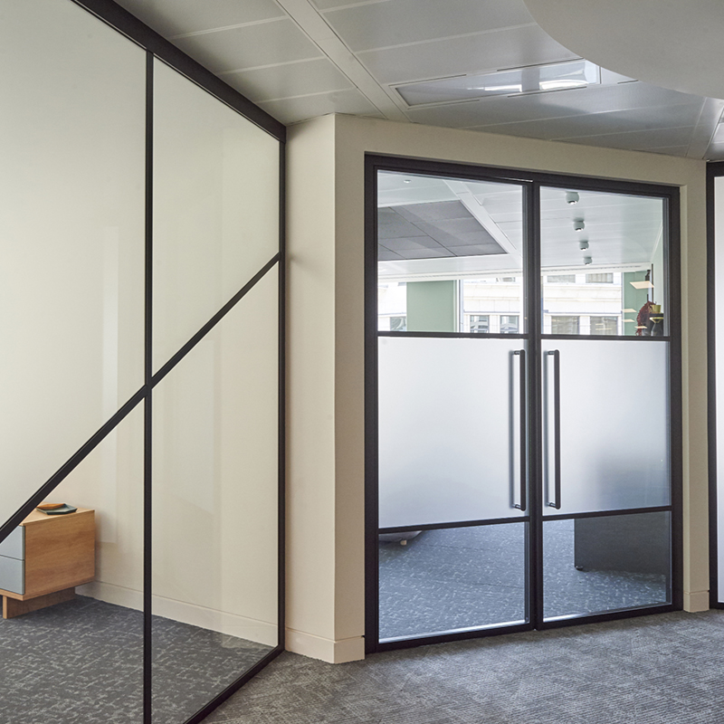 an office space with minimalistic glass office door designs