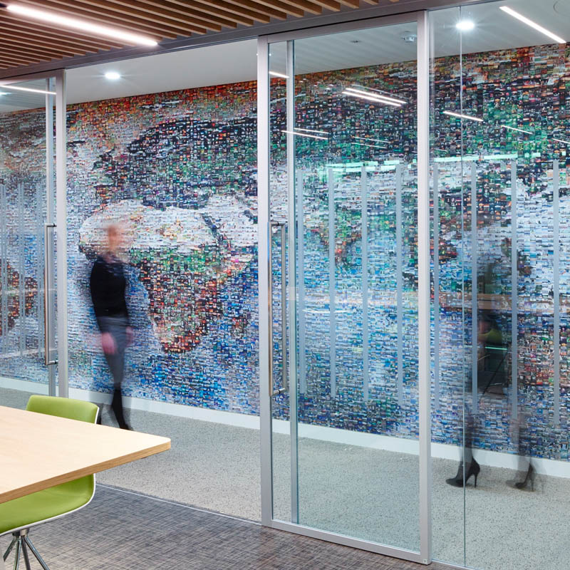 an office design with a work of art in the wallway